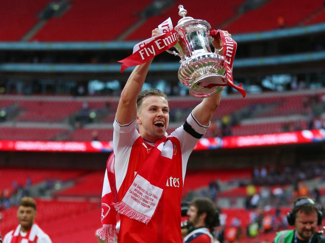 Arsenal's Rob Holding celebrates with the trophy during the Emirates FA Cup Final match between Arsenal and Chelsea at Wembley Stadium on May 27, 2017 in London, England | Photo by Catherine Ivill - AMA/Getty Images