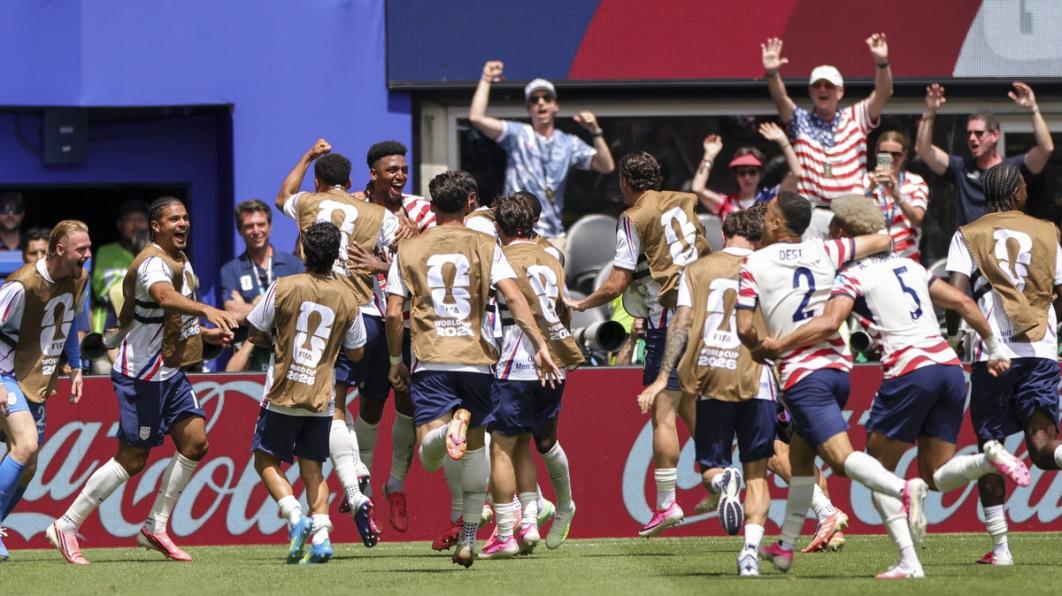 The entire team joins Alex Freeman in celebration of his goal against Australia