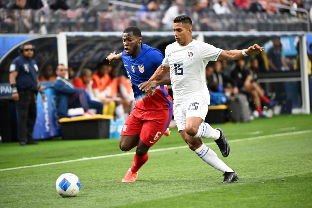 Yunus Musah for the USMNT contests a ball with a Panama player during a match