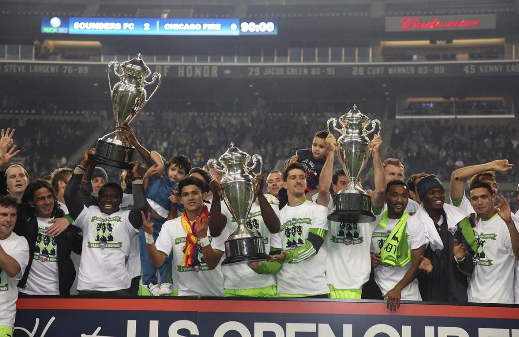 Seattle Sounders FC players celebrate with a third consecutive U.S. Open Cup trophy after defeating the Chicago Fire 2-0 in the 2011 U.S. Open Cup Final at Lumen Field (Image Credit: Otto Greule Jr/Getty Images)