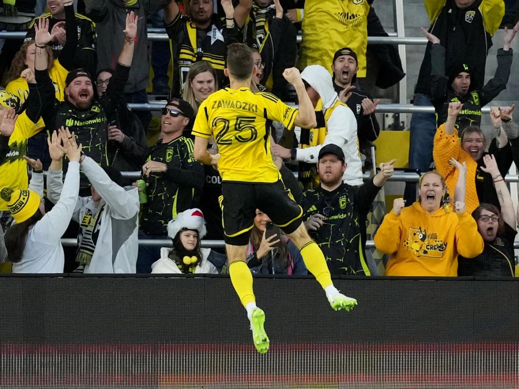 Zawadzki celebrates with Crew supporters | Photo by Jason Mowry/Getty Images
