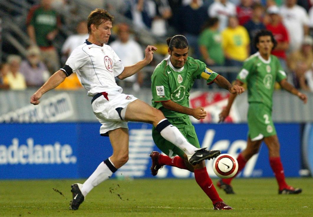 Brian McBride takes the ball from Mexico’s Rafael Marquez during the 2006 World Cup Qualifying match at Crew Stadium on Sept. 3, 2005 in Columbus, Ohio. | Photo by Victor Decolongon/Getty Images