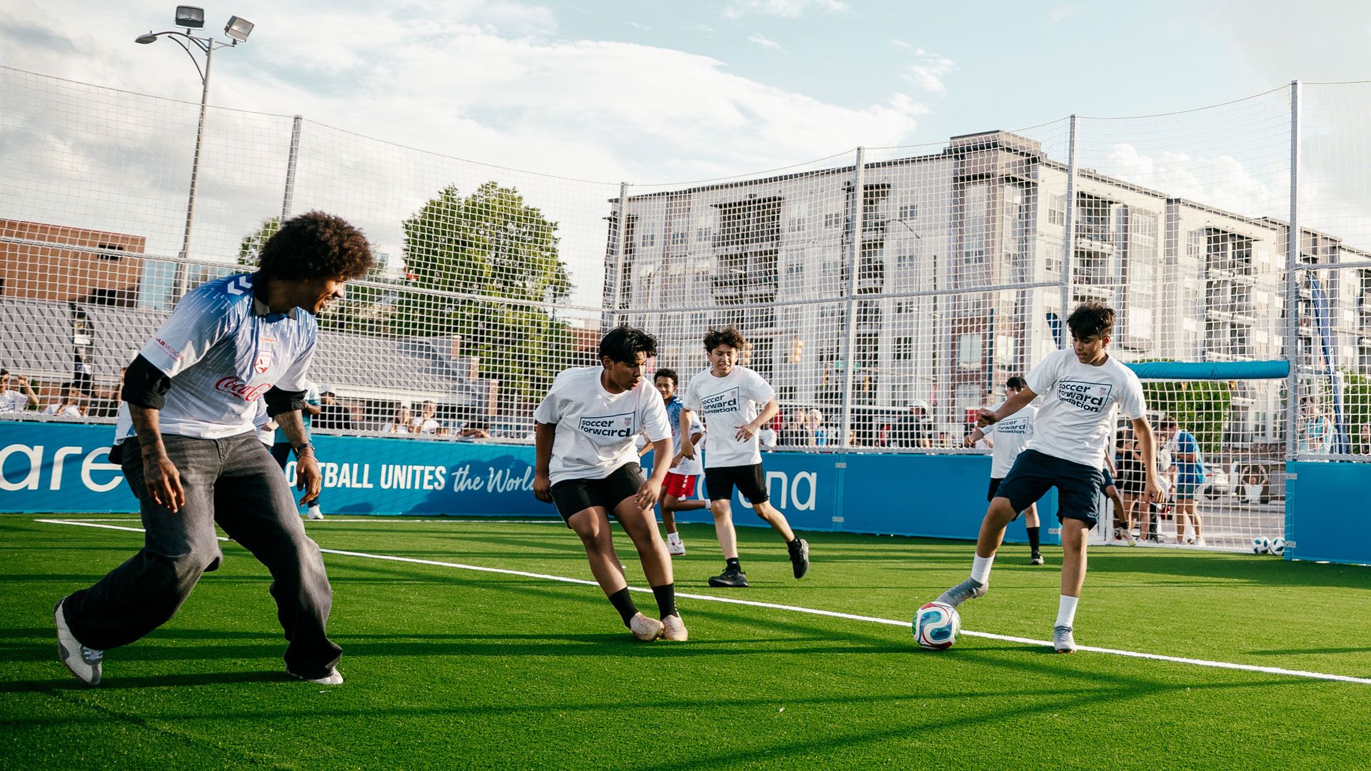 Youth players, playing soccer on a Fifa Arenas pitch