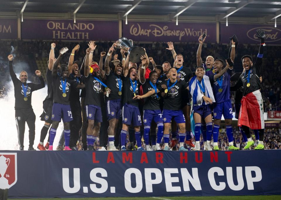 Orlando City SC players lift the 2022 U.S. Open Cup trophy on stage after a game between Sacramento Republic FC and Orlando City SC at Exploria Stadium on September 7, 2022, in Orlando, FL. (Photo by Roy K. Miller/ISI Photos/Getty Images)