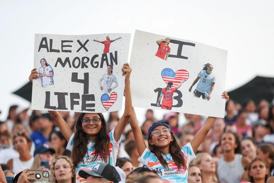 Fans hold signs for Alex Morgan #13 (Photo by Meg Oliphant/Getty Images)