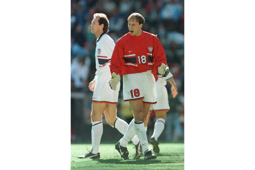 goalkeeper kasey keller in red jersey and white shorts