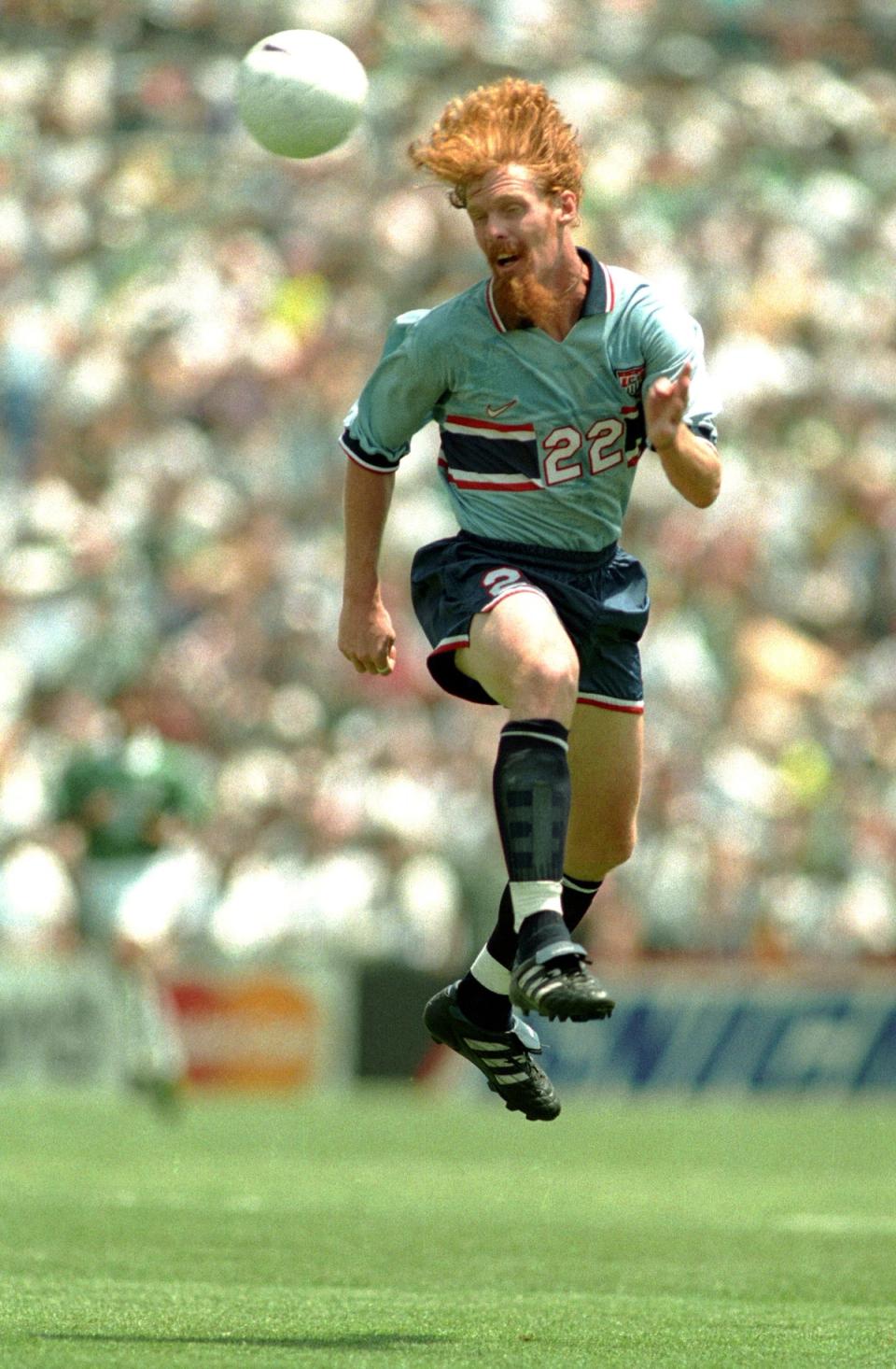 Alexi Lalas jumps for a header