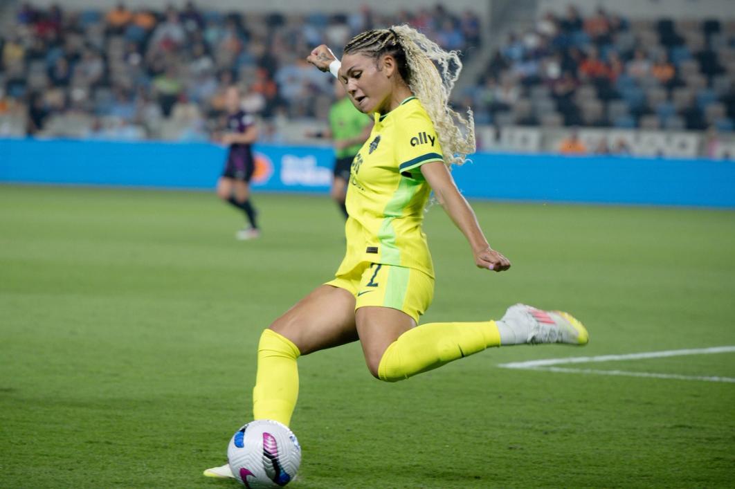 Trinity Rodman striking a ball