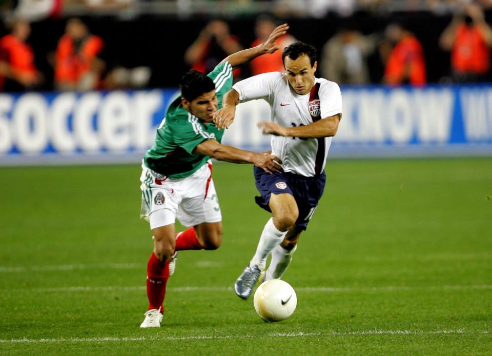 Landon Donovan gets past Carlos Salcido on his way to scoring his team's second goal in the ninety-first minute of their international match on February 7, 2007 at the University of Phoenix Stadium in Glendale, Arizona. (Photo by Stephen Dunn/Getty Images)