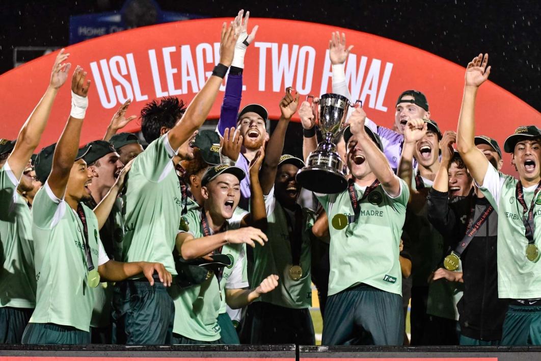 Vermont Green FC players lift their second consecutive USL League Two Final trophy | Photo courtesy Vermont Green FC