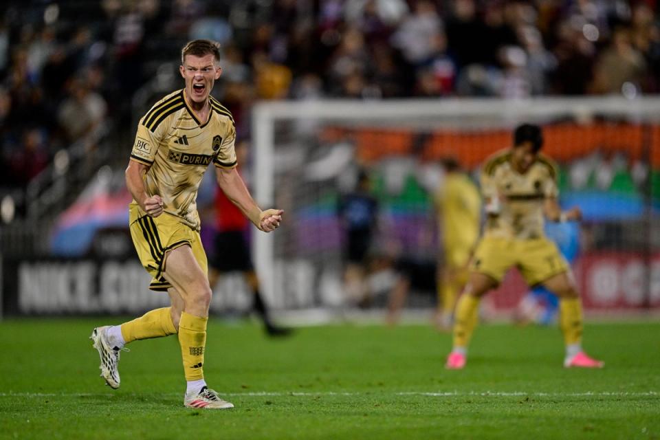 Chris Durkin #8 celebrates a team goal in the second half against the Colorado Rapids at DICK'S Sporting Goods Park (Photo by Dustin Bradford/USSF/Getty Images)