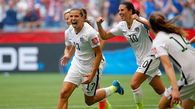 Tobin Heath celebrates with USWNT teammates Carli Lloyd and Megan Rapinoe