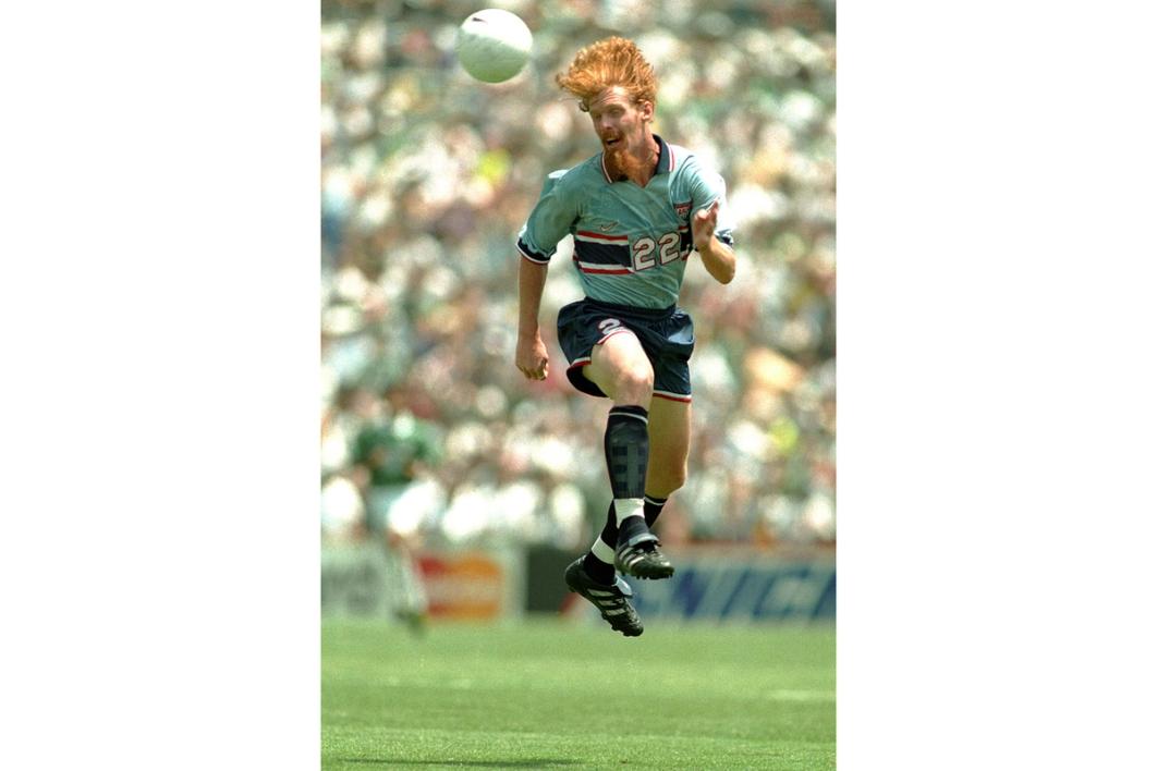 Alexi Lalas jumps for a header