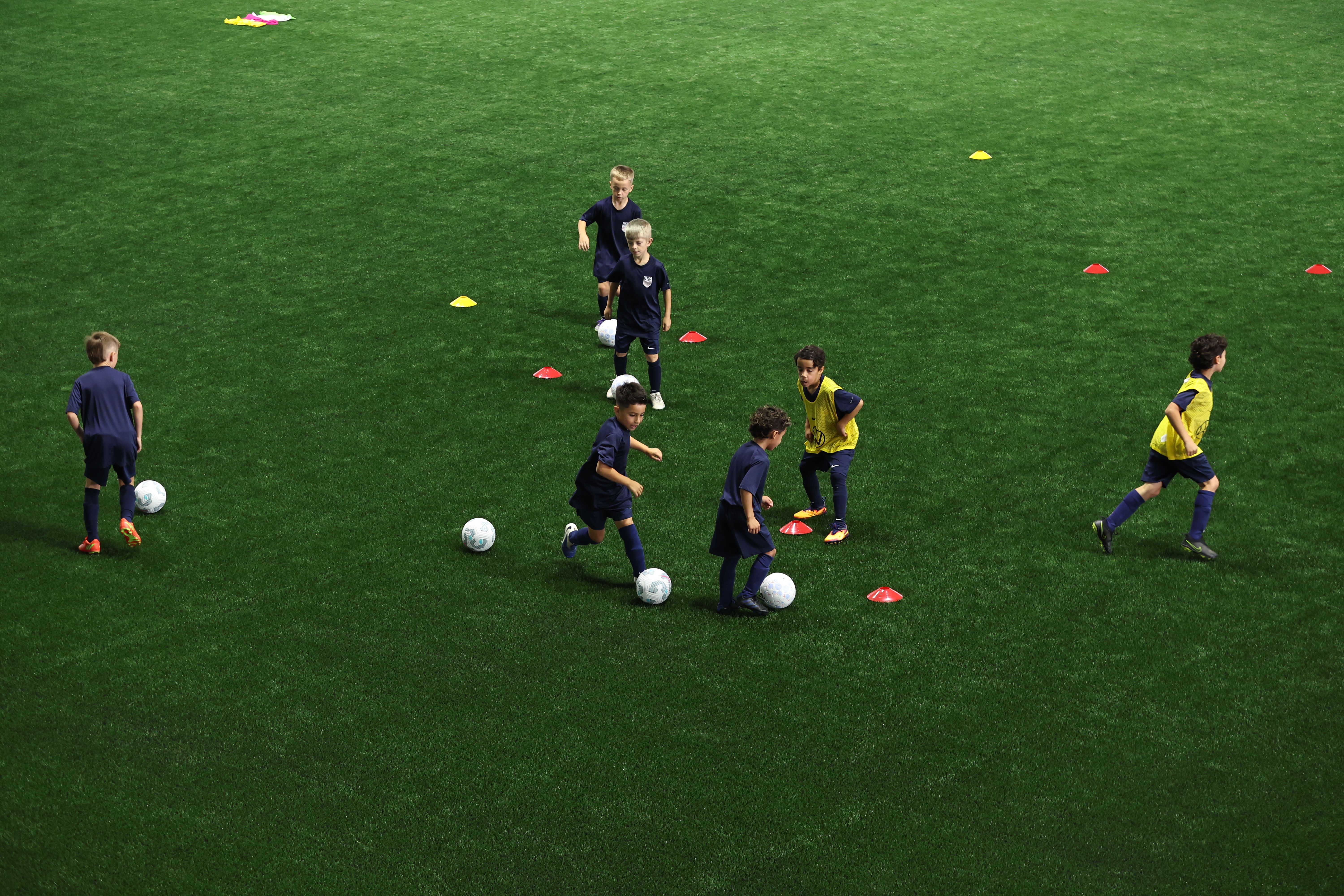 Young player about to kick a soccer ball during indoor training