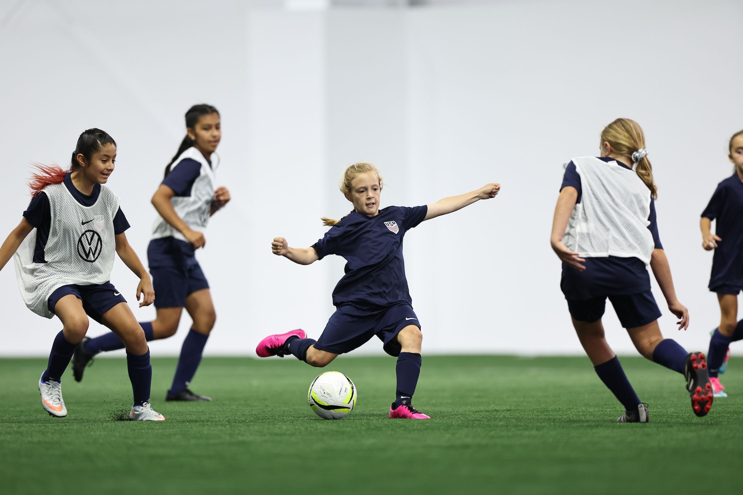 Youth players passing and receiving during an outdoor small-sided soccer activity
